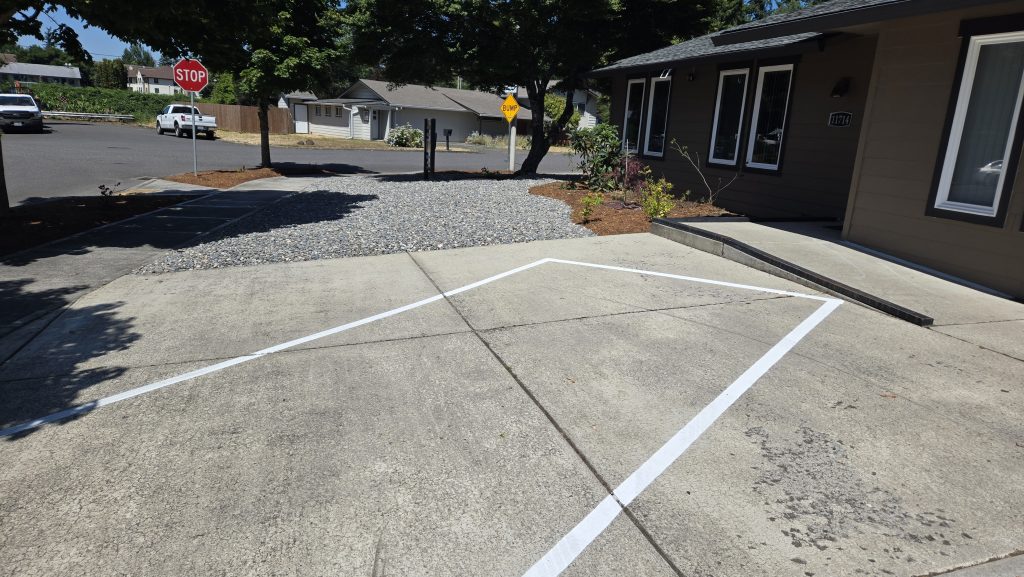 Stop sign on residential street corner with driveway